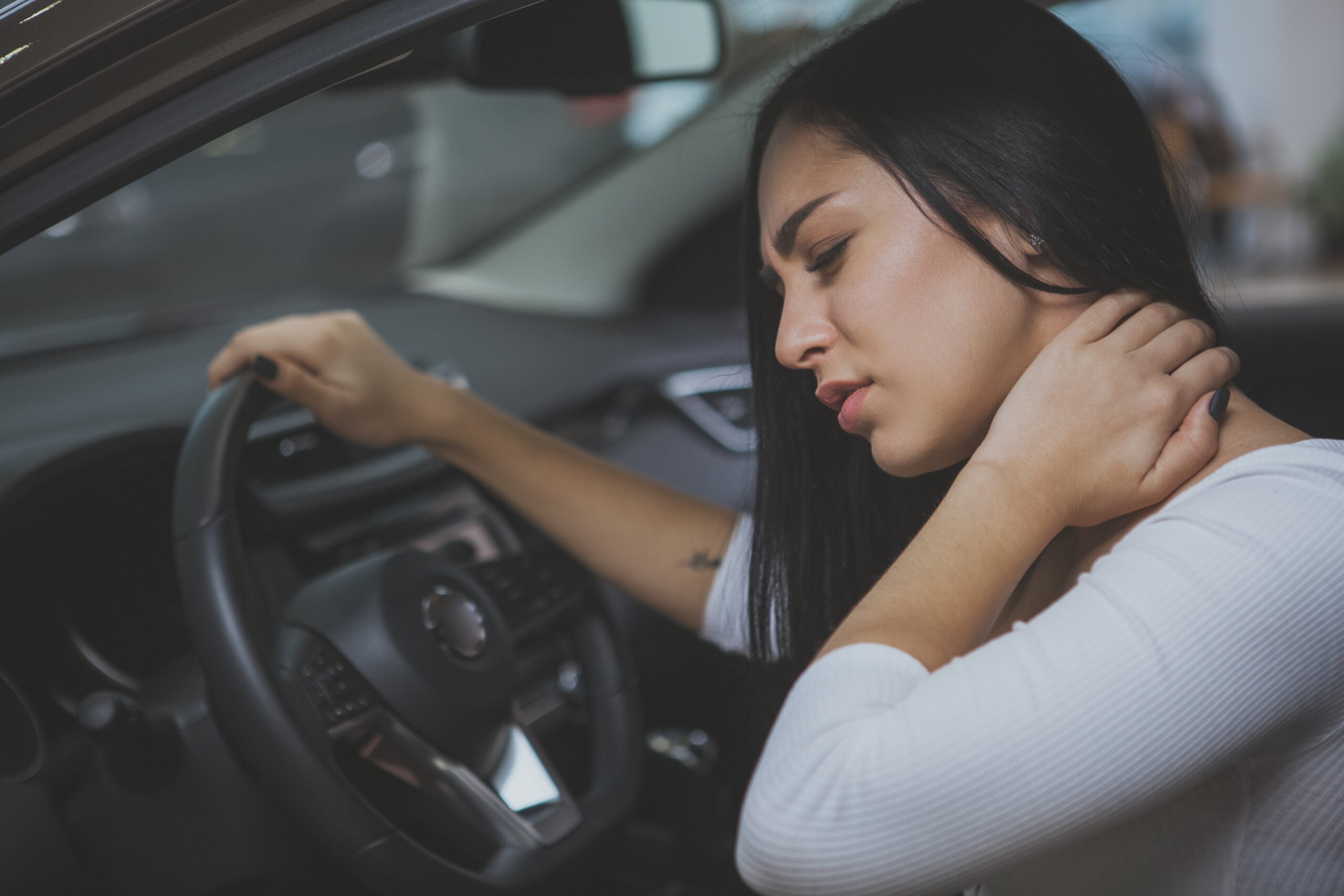 Person with whiplash neck injury from car accident needing treatment in East Bay